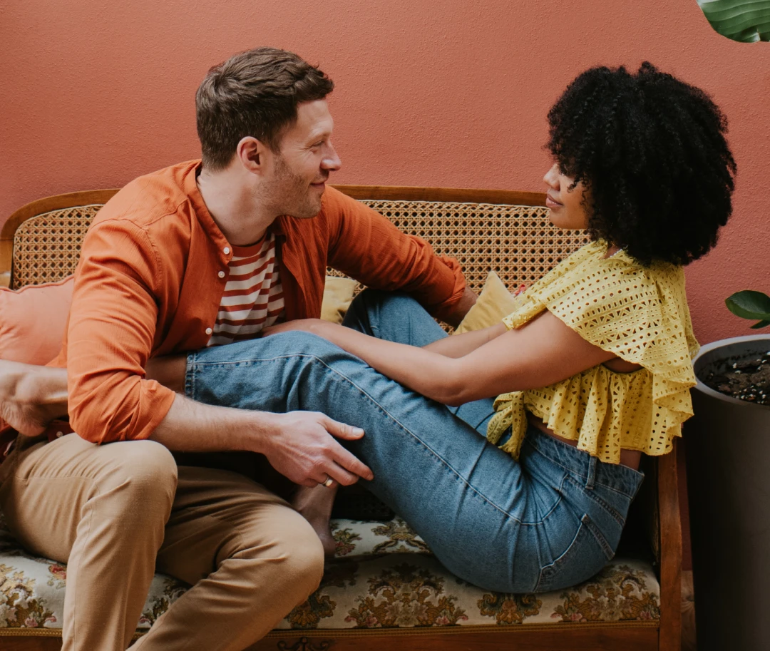 A man and woman share a moment on the couch