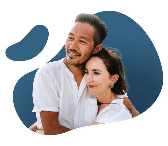 A man and woman smile against a blue background